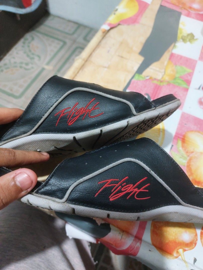Jordan Flight Slides Black Red (Category: Slippers & Slides) located in Manila. Submitted by mightyturtle_e6e74b (Listing ID 1462491430, Image 2). Description: - Black Jordan slides with red accents - Features the iconic Jumpman logo and 'Flight' text - Grippy sole pattern for good traction - Perfect for casual wear or post-sports relaxation - Shows some signs of wear on straps and soles (please check photos for details).