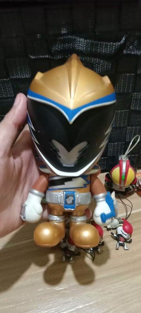 Kamen Rider Chibi Figures & Large Figure Set (Category: Figurines & Statues) located in Gapan. Submitted by montesnora80204 (Listing ID 1462678060, Image 2). Description: - Set of Kamen Rider chibi figures and one larger figure. - Features various Kamen Rider characters. - Large figure has '©2013 T.T.T BP.2013 CHINA' stamped on the bottom. - Some figures include strings, possibly for hanging. - Perfect for collectors and fans of Kamen Rider..