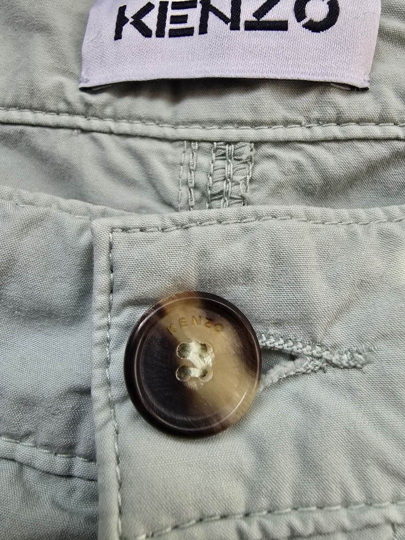 KENZO Light Blue Cotton Blend Trousers (Category: Luxury Apparel) located in Manila. Submitted by annemanzano120906 (Listing ID 1462551567, Image 3). Description: - Light blue KENZO trousers - Comfortable cotton blend fabric - Features iconic KENZO 'K' logo embroidery - Classic button fly closure with unique tortoiseshell button - Relaxed fit with a trendy cropped leg - Ideal for effortless casual outfits.