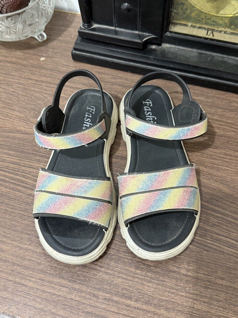 Kids Rainbow Glitter Strap Sandals in 32eu (Category: Babies & Kids Fashion) located in Binan City. Submitted by prelovedlagunaph (Listing ID 1462623509, Image 1). Description: - Adorable kids' sandals - Features sparkling rainbow glitter straps - Comfortable sole for all-day wear - Adjustable velcro closure for a perfect fit - Ideal for daily use or vacation fun.