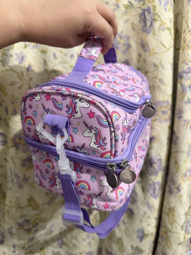 Kids Unicorn Rainbow Lunch Bag (Category: Babies & Kids Fashion) located in Binan City. Submitted by prelovedlagunaph (Listing ID 1462620206, Image 3). Description: - Adorable pink lunch bag featuring cute unicorns and rainbows. - Two spacious zippered compartments to keep food fresh. - Convenient top handle for easy carrying. - Includes a detachable shoulder strap for versatile wear. - Ideal for school lunches, day trips, or picnics. - Easy-to-c