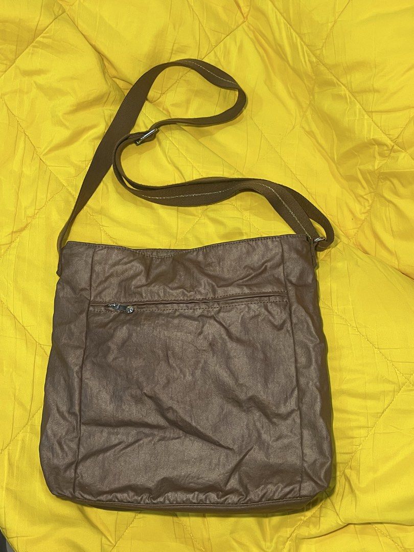 Kipling Brown Nylon Crossbody Bag (Category: Cross-body Bags) located in Makati City. Submitted by andiii_17 (Listing ID 1462585128, Image 2). Description: ORIGINAL PRICE: ₱4,500 - Brand: Kipling - Color: Brown - Material: Nylon - Style: Crossbody bag - Features: Multiple zippered pockets (front & back), adjustable strap - Interior: Spacious, ideal for everyday essentials.