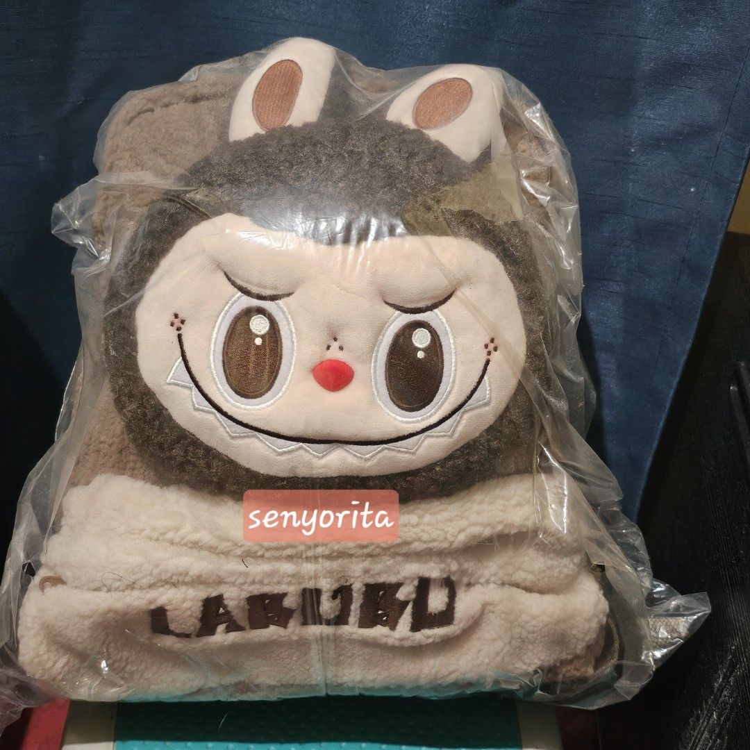 LABUBU Plush Toy with Bunny Ears (Category: Backpacks) located in San Pedro. Submitted by yanee26 (Listing ID 1462562654, Image 1). Description: - Adorable Labubu plush toy - Soft, fuzzy brown body - Cute character face with big eyes and red nose - Ideal for collectors or as a gift -brand new .