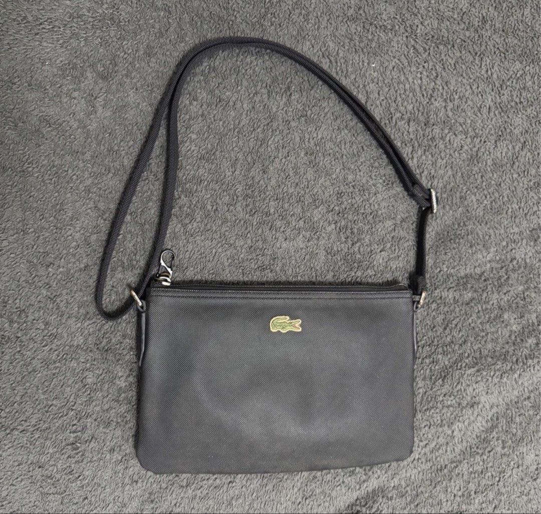 Lacoste Black Crossbody Bag (Category: Cross-body Bags) located in Pasay City. Submitted by szepter (Listing ID 1462445381, Image 1). Description: - Authentic Black Lacoste Crossbody Bag - Secure Zipper Closure - Adjustable Strap for Comfort - Interior features 'LACOSTE' Branding - Includes Small Tag - Ideal for Everyday Use.
