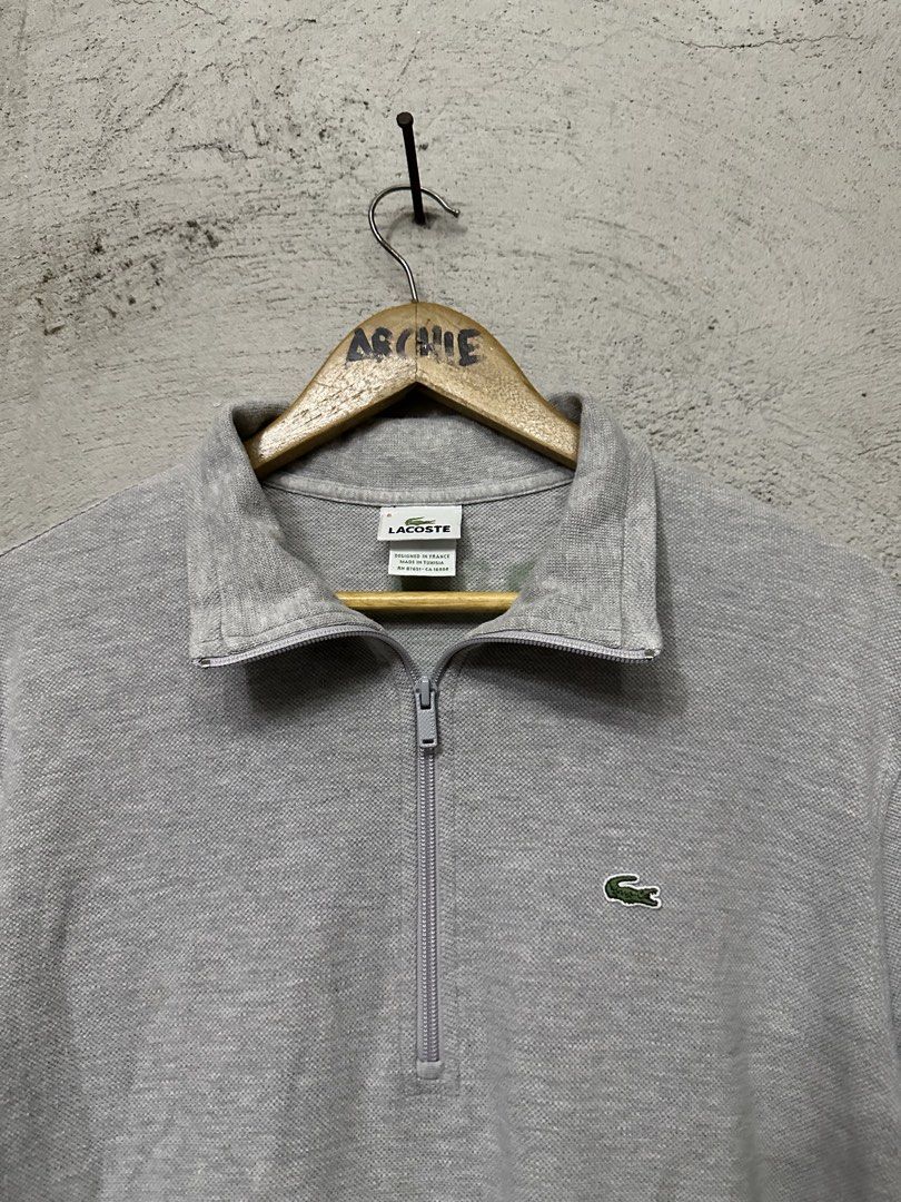 Lacoste Grey Quarter Zip Long Sleeve Sweatshirt (Category: Coats, Jackets and Outerwear) located in Quezon City. Submitted by stre3tw3ar (Listing ID 1462614826, Image 2). Description: - Grey Lacoste sweatshirt - Quarter zip neckline with a collar - Small green crocodile logo on the chest - Lacoste text embroidered on the back collar - Long sleeves with ribbed cuffs and hem - Made in Tunisia.