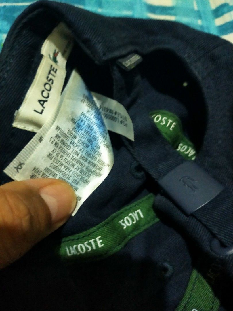 Lacoste Navy Blue Cap with Crocodile Logo (Category: Caps & Hats) located in Makati City. Submitted by lemron18 (Listing ID 1462482497, Image 2). Description: - Classic navy blue Lacoste cap - Features the iconic green crocodile logo on the front - Adjustable strap at the back for a comfortable fit - Made from durable material - Perfect for everyday wear or sports activities.