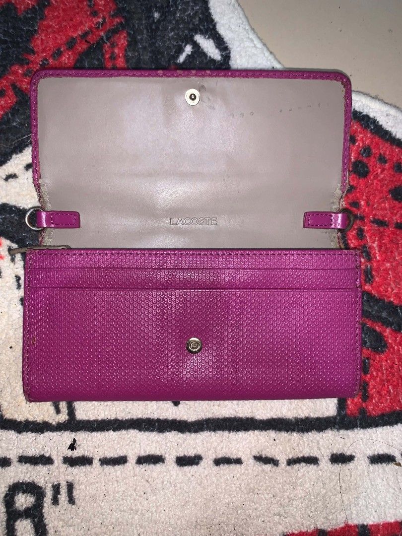 Lacoste Pink Textured Trifold Wallet (Category: Wallets & Card holders) located in Manila. Submitted by kirbykyle.562 (Listing ID 1462642159, Image 2). Description: - Pink Lacoste wallet - Textured exterior with gold crocodile logo - Interior card slots - Button closure - Shows some signs of wear on edges and inside - Still functional and stylish.