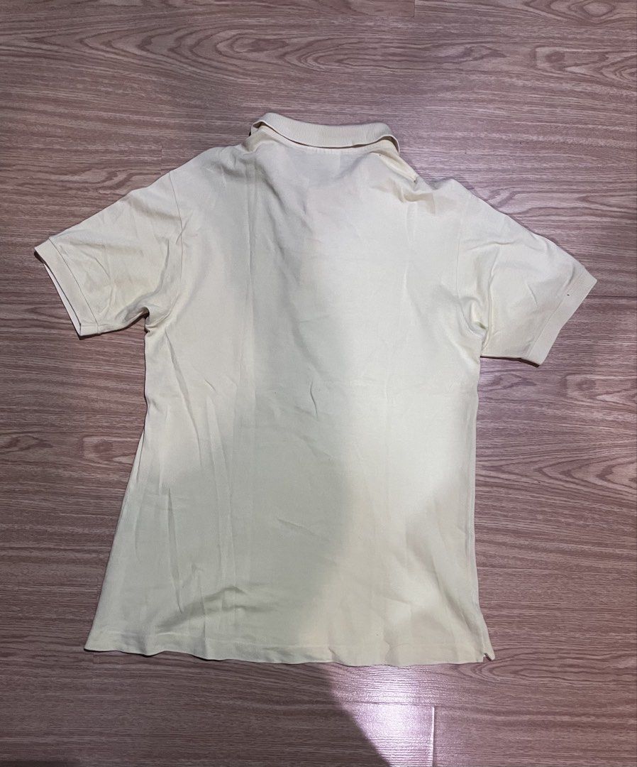 Lacoste Polo Shirt - Light Yellow (Category: Tshirts & Polo Shirts ) located in Quezon City. Submitted by reecepalafox (Listing ID 1462521110, Image 2). Description: - Classic light yellow Lacoste polo shirt - Iconic embroidered crocodile logo on chest - Short sleeves with ribbed collar - Two-button placket - Versatile for casual or smart-casual outfits.