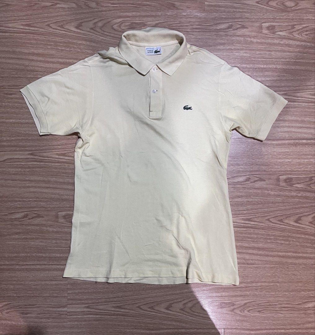 Lacoste Polo Shirt - Light Yellow (Category: Tshirts & Polo Shirts ) located in Quezon City. Submitted by reecepalafox (Listing ID 1462521110, Image 1). Description: - Classic light yellow Lacoste polo shirt - Iconic embroidered crocodile logo on chest - Short sleeves with ribbed collar - Two-button placket - Versatile for casual or smart-casual outfits.