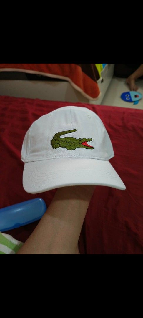 Lacoste White Cap with Green Crocodile Logo (Category: Caps & Hats) located in Cebu City. Submitted by dediosmark83726 (Listing ID 1462527164, Image 1). Description: - Classic white Lacoste cap - Features the iconic green crocodile logo - Adjustable strap with a stylish gold buckle - Versatile for everyday wear.
