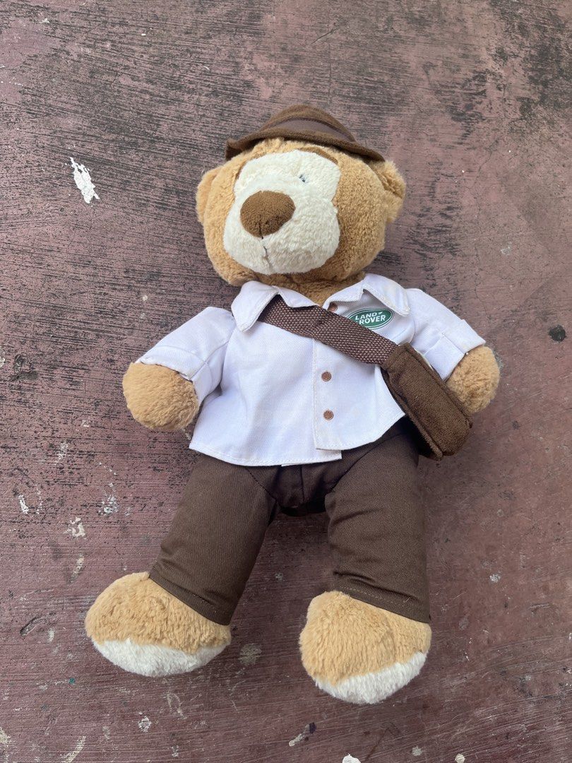 Land Rover Teddy Bear Plush Toy (Category: Plushies & Soft Toys) located in Cainta. Submitted by r.m.j. (Listing ID 1462447650, Image 1). Description: Cute Land Rover teddy bear with Land Rover logo shirt, pants, hat, and messenger bag. Perfect for collectors or fans. Condition : 8/10 needs wash, minor dirt in white polo, needs minor restitch .