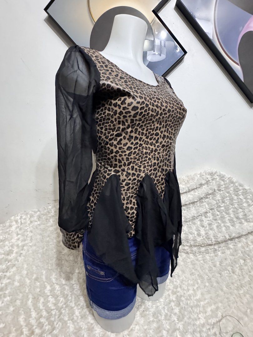Leopard Print Sheer Sleeve Peplum Top (Category: Others Tops) located in Marikina City. Submitted by lorradel (Listing ID 1462460684, Image 2). Description: - Eye-catching leopard print - Sheer black sleeves for a stylish contrast - Flattering peplum hem with ruffled chiffon detail - Versatile: pairs well with jeans or shorts - Unique design for a bold, statement look - Ideal for evening wear or making a fashion statement - MAY HAVE some washable