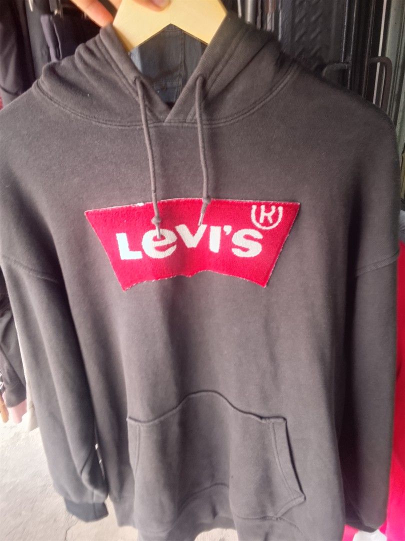 Levi's Hoodie (Category: Hoodies) located in Manila. Submitted by warmcloud-06f3 (Listing ID 1462558409, Image 1). Description: - Classic Levi's hoodie - Dark grey color - Iconic red and white logo patch on front - Front pocket - Drawstring hood - Size: L - Made in Pakistan - Ideal for casual wear.