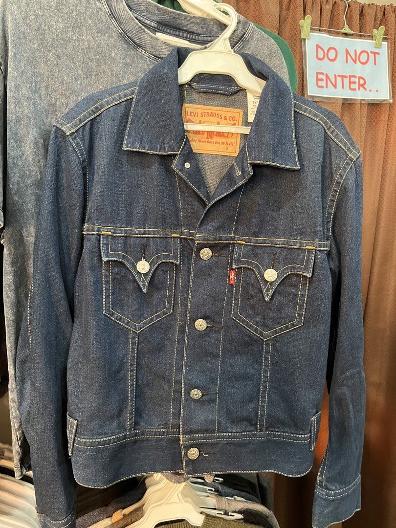 Levi's Type 1 Denim Jacket - Size S (Category: Coats, Jackets and Outerwear) located in Tabuk. Submitted by collectors_thrift_shop (Listing ID 1462450757, Image 1). Description: - Classic Levi's Type 1 denim jacket - Dark wash - Iconic design with two chest pockets - Button closure - Made in Vietnam - Size S - Great for layering or wearing on its own - Timeless wardrobe staple.