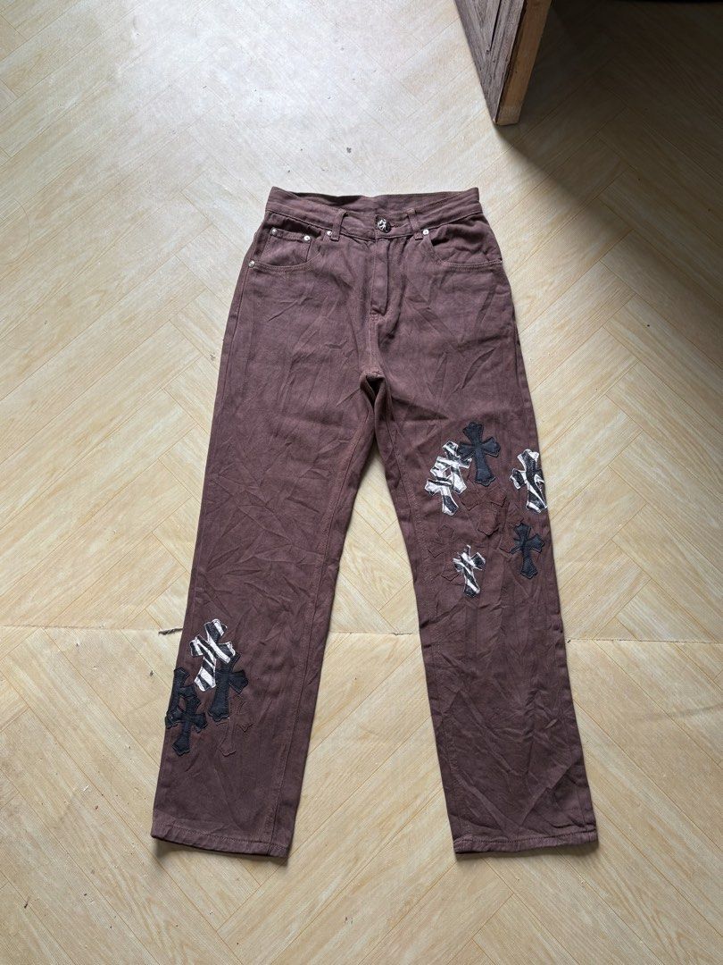 LEVIS x CHROMEHEARTS (Category: Jeans) located in Iligan City. Submitted by seddicmoti2002 (Listing ID 1462459728, Image 1). Description: - Brown denim jeans - Unique cross patches on front and back - Some patches feature zebra print detail - Button and zip fly closure - Classic five-pocket design - Statement piece for a distinctive style.