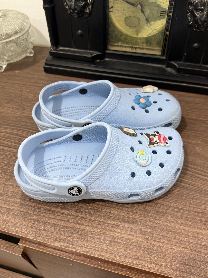 Light Blue Crocs with Charms in J1 (Category: Babies & Kids Fashion) located in Binan City. Submitted by prelovedlagunaph (Listing ID 1462622718, Image 3). Description: - Light blue Crocs - Adorable cartoon charms included - Easy slip-on and off design - Ideal for casual everyday wear - Minor scuffs on soles from normal use.