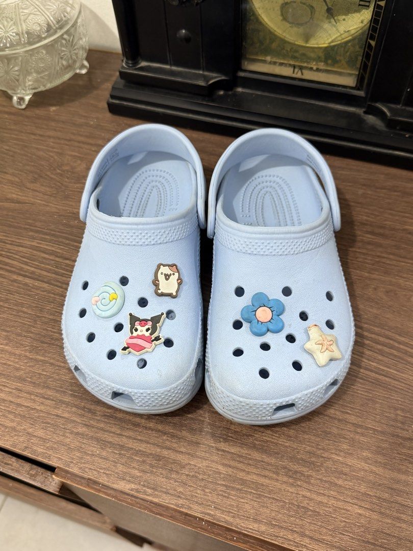 Light Blue Crocs with Charms in J1 (Category: Babies & Kids Fashion) located in Binan City. Submitted by prelovedlagunaph (Listing ID 1462622718, Image 2). Description: - Light blue Crocs - Adorable cartoon charms included - Easy slip-on and off design - Ideal for casual everyday wear - Minor scuffs on soles from normal use.