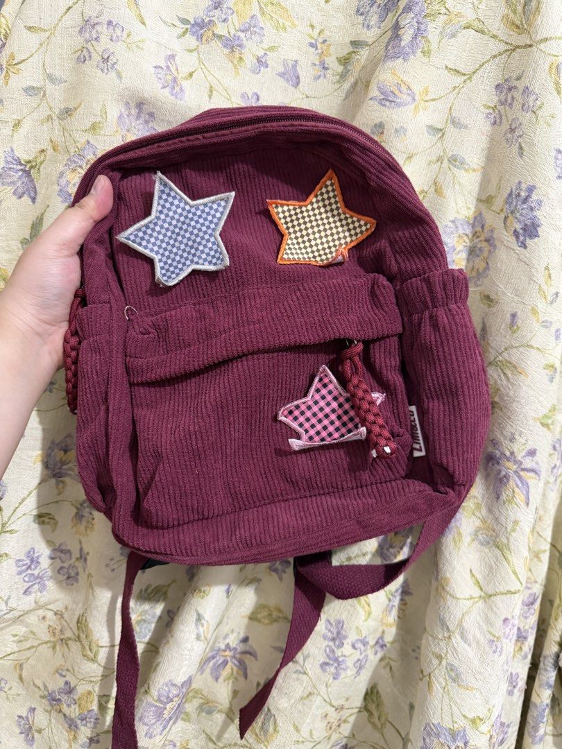 Lim & Co. Corduroy Backpack with Star Patches (Category: Backpacks) located in Binan City. Submitted by prelovedlagunaph (Listing ID 1462620318, Image 1). Description: - Adorable burgundy corduroy backpack - Fun star patches all over the front - Spacious main compartment with an inner pocket - Convenient side pockets for extra storage - Adjustable straps for a comfortable fit - Ideal for school, college, or everyday adventures.
