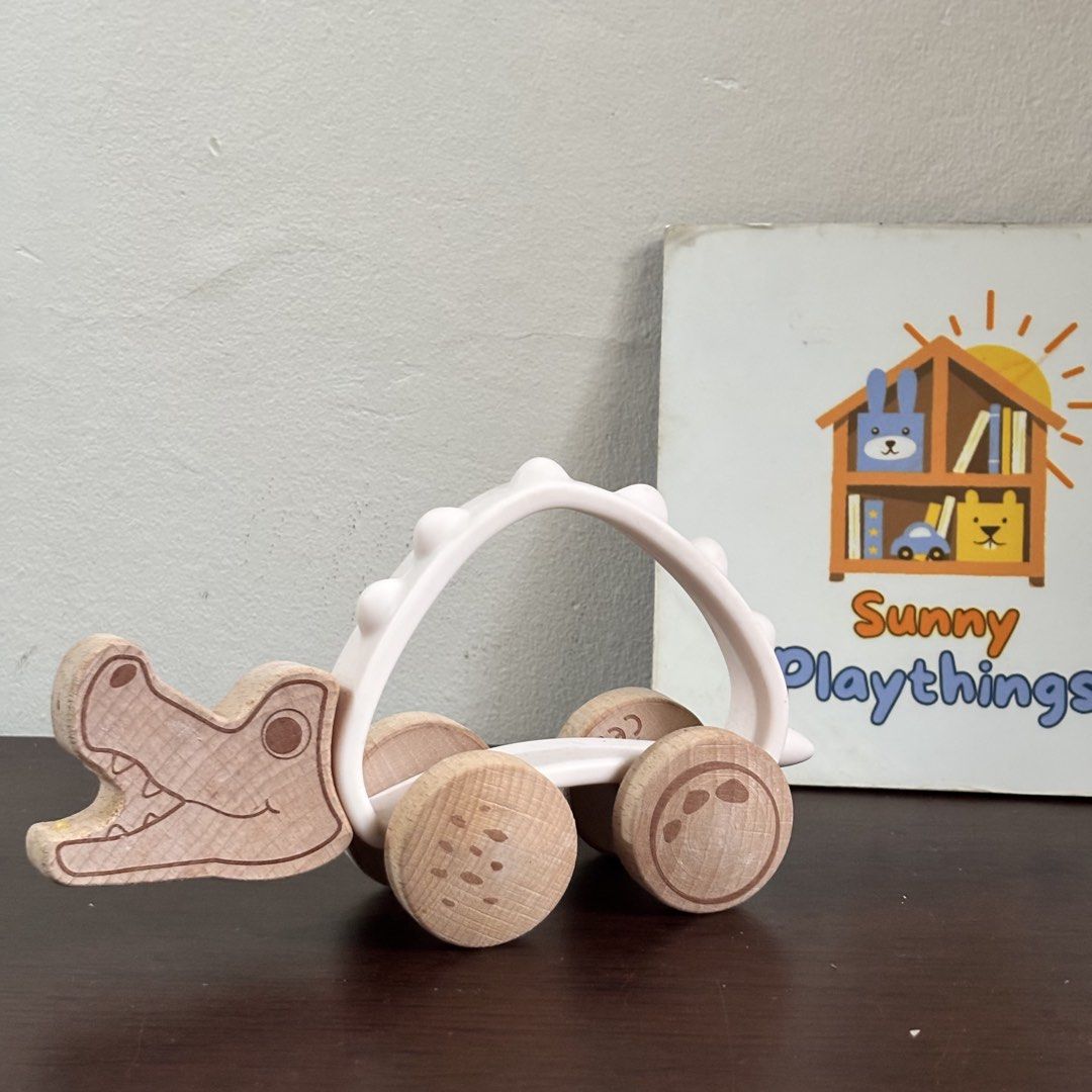 Little town Wooden Crocodile Pull Toy (Category: Kids Toys) located in Taguig. Submitted by sunnyplaythingsph (Listing ID 1462478358, Image 1). Description: - Adorable wooden crocodile toy on wheels. - Features a unique white arch body with little bumps. - Wheels have a fun smiley face design. - Perfect for toddlers to pull along and play with. .