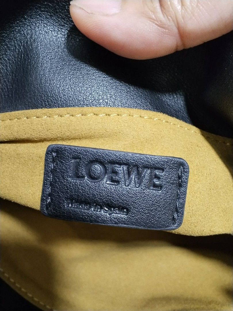 Loewe Black Leather Shoulder Bag (Category: Cross-body Bags) located in Manila. Submitted by bagelyascollection (Listing ID 1462612737, Image 2). Description: - Brand: Loewe - Type: Shoulder Bag - Color: Black - Material: Leather - Features: Embossed Loewe anagram logo, suede lining, gold hardware - Strap Detail: Unique knotted detail - Origin: Made in Spain.