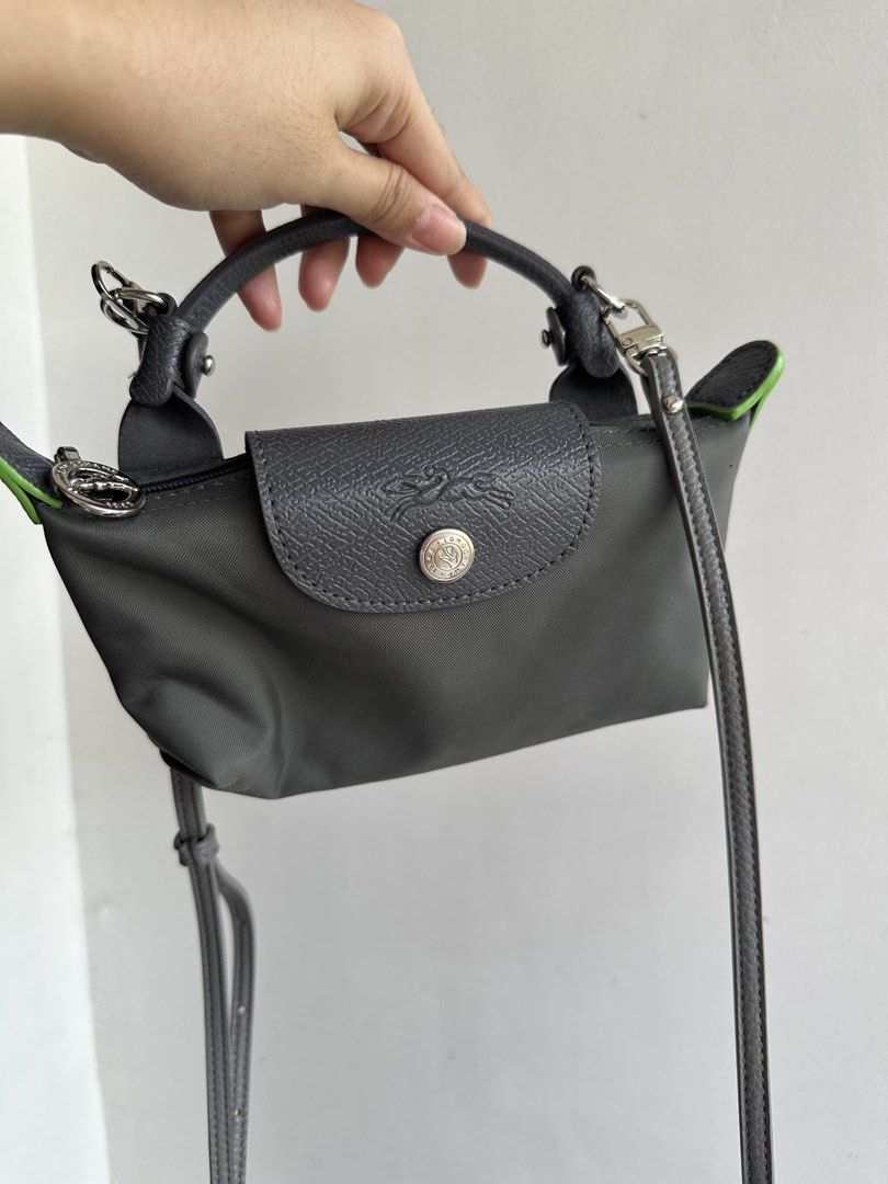 Longchamp Le Pliage Green Trim Small Top Handle Bag (Category: Luxury Bags & Wallets) located in Bombon. Submitted by cookiespreloveed (Listing ID 1462499286, Image 1). Description: - Grey Longchamp Le Pliage bag - Small size - Top handles and long strap - Green trim detail - Zipper closure - Clean interior - Ideal for everyday use Replaced sling Bought it also here in carousel .