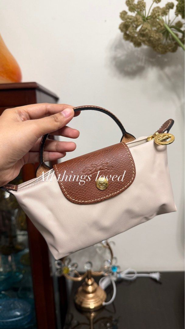 Longchamp Le Pliage Pouch Beige/Brown (Category: Purses & Pouches) located in Cavite. Submitted by denimloveph2020 (Listing ID 1462603881, Image 1). Description: - Authentic Longchamp pouch - Classic beige nylon with brown leather trim - Gold zipper and hardware - Ideal for organizing essentials or as a small clutch - Compact and easy to carry MAY POUCH MAY CARD PWDE PANG GIFT RFS NEED KO FUNDS MAY BLACK NA AKO KAYA UN NALANG AKIN ORIG YAN BIGAY 