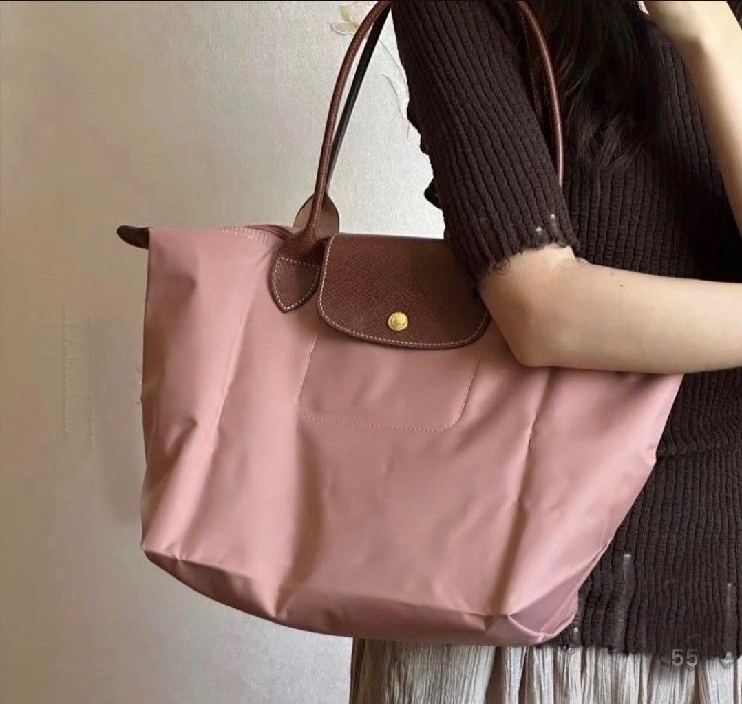 Longchamp Le Pliage Tote Bag Dusty Rose (Category: Luxury Bags & Wallets) located in Manila. Submitted by aizahsy (Listing ID 1462584847, Image 1). Description: - Classic Longchamp tote bag - Lovely dusty rose color - Brown leather trim and handles - Folds flat for easy storage - Ideal for everyday use, travel, or carry-on - Spacious interior - Secure snap button closure.