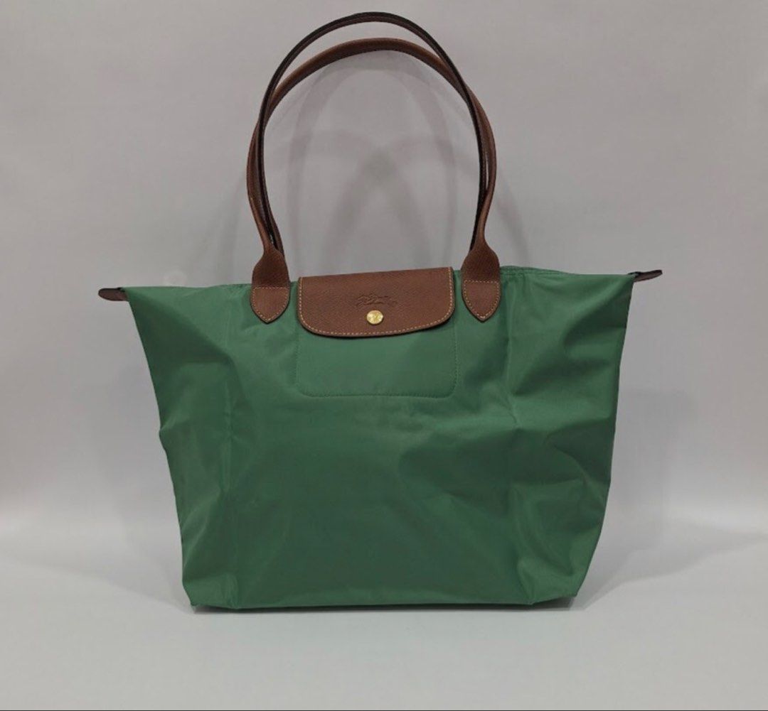 Longchamp Le Pliage Tote Bag Green (Category: Luxury Bags & Wallets) located in Manila. Submitted by elcanto (Listing ID 1462626245, Image 1). Description: - Model/Series: Longchamp Le Pliage Original Large Shoulder Bag (Reference Code: L1899089P84) Color: Sauge (a soft muted sage green tone) paired with classic brown Russian leather trimmings. Dimensions: Approximately 12.2” W (at base) x 11.8” H x 7.5” D (31 cm x 30 cm x 19 cm).Handle Drop: 9.8