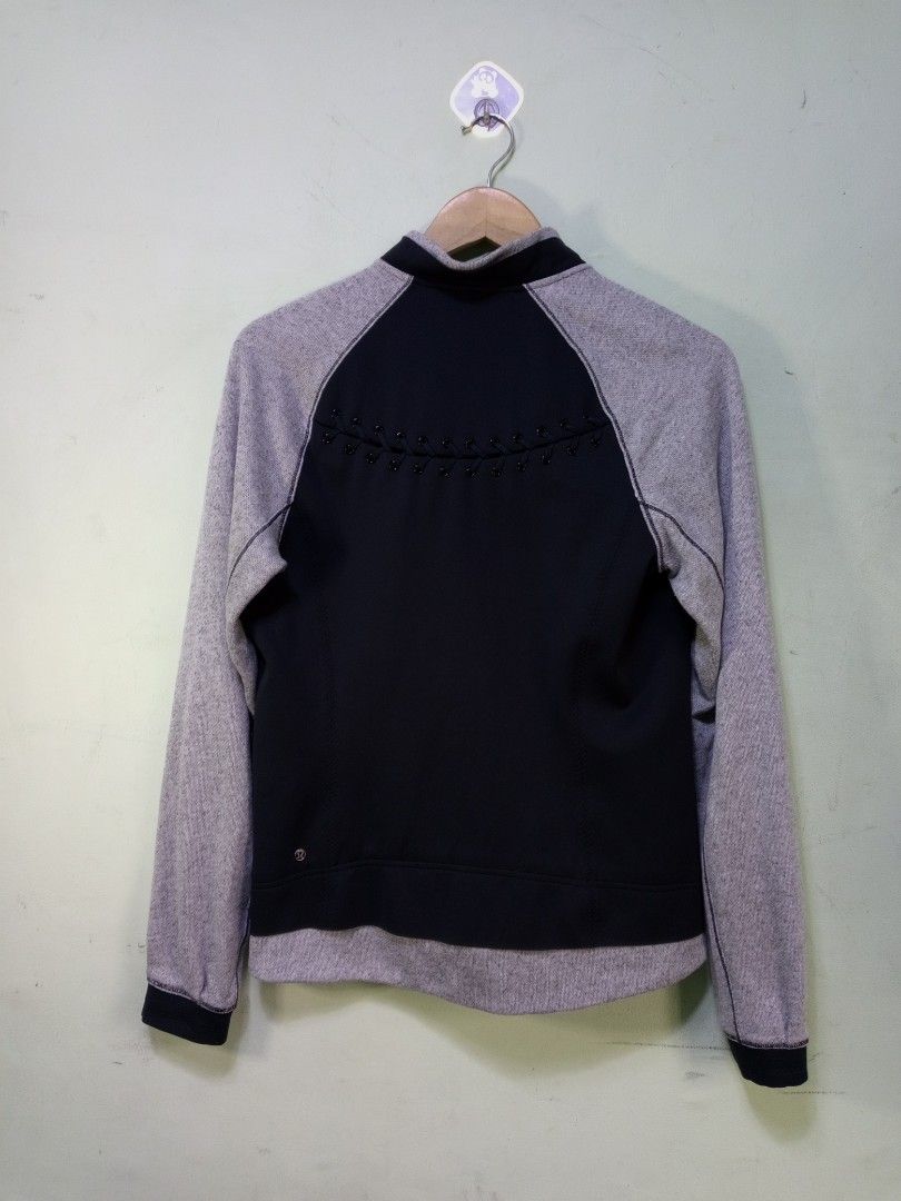 Lululemon Black Grey Zip-Up Jacket (Category: Coats, Jackets and Outerwear) located in Manila. Submitted by onewikstraight (Listing ID 1462565601, Image 2). Description: - Lululemon jacket in black and grey. - Raglan sleeves for comfortable movement. - Full zipper front closure. - Two secure zip pockets for essentials. - Unique decorative beaded detail on the back. - Size 6 19W 25L - Versatile for workouts or everyday casual wear. - Combines comf