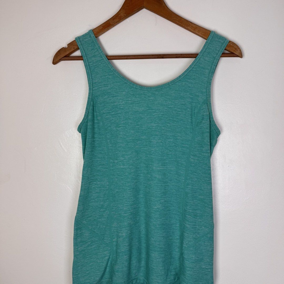 Lululemon Teal Ruffle Tank Top (Category: Activewear) located in Calasiao. Submitted by liascorner (Listing ID 1462601090, Image 2). Description: - Lululemon teal tank top - V-neck design - Cute tiered ruffle detail on the front - Heathered fabric texture - Versatile for workouts or casual wear - Features Lululemon logo on the hem.