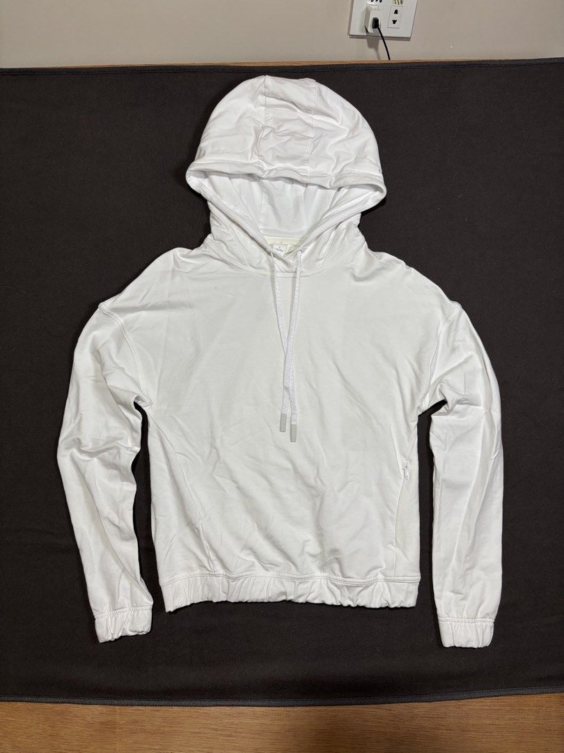 Lululemon White Cotton Blend Hoodie Size 2 (Category: Coats, Jackets and Outerwear) located in Mabalacat. Submitted by _limitlessfashion (Listing ID 1462460312, Image 1). Description: - White Lululemon hoodie - length 21 - width 17 - Comfortable cotton and elastane blend - Adjustable drawstring hood - Elasticated cuffs and hem for a snug fit - Convenient side zippered pocket with Lululemon logo zipper pull - Versatile for workouts or casual every