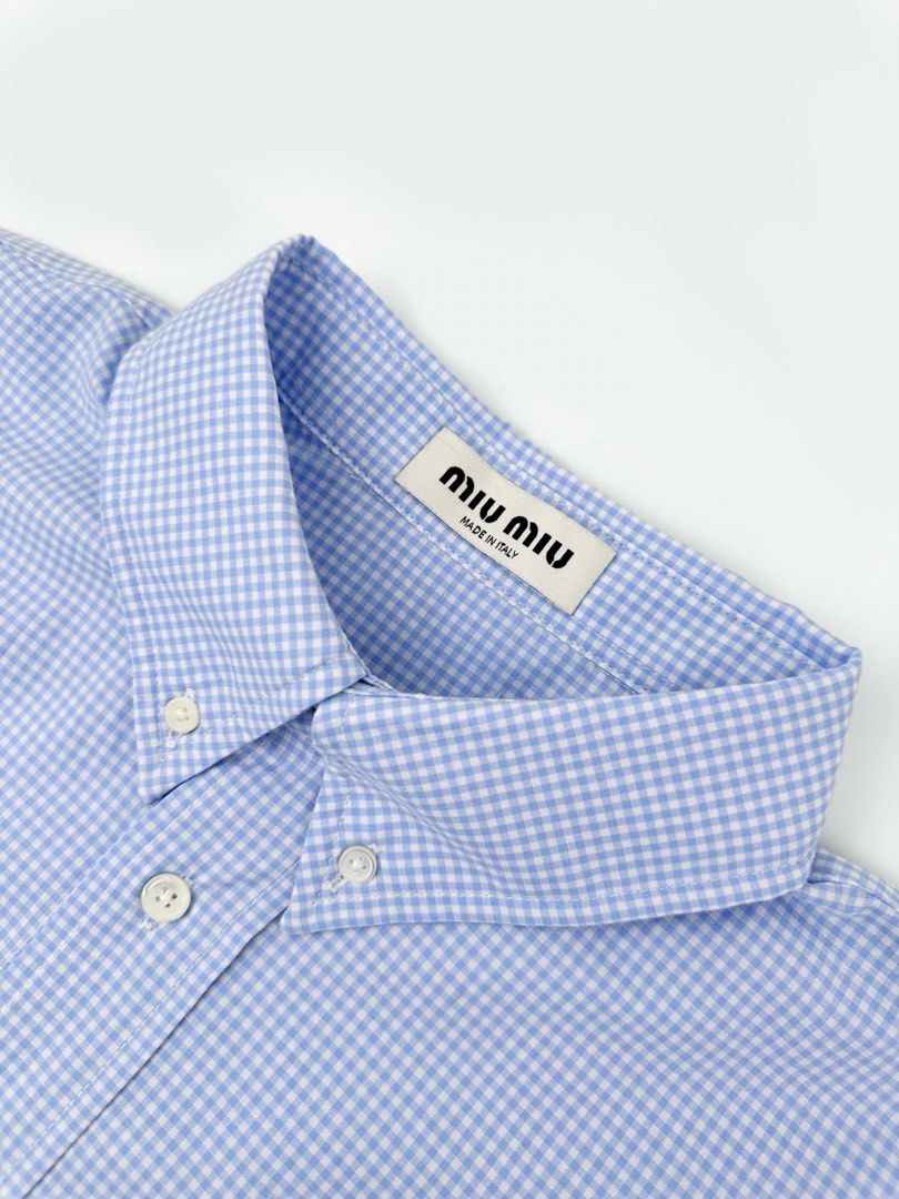 M M Blue Gingham Button-Down Shirt (Category: Shirts) located in Manila. Submitted by randomreps (Listing ID 1462586567, Image 3). Description: - Classic blue gingham shirt - Miu Miu embroidered logo on chest - Button-down collar - Long sleeves - Made in Italy - Ideal for smart casual outfits.