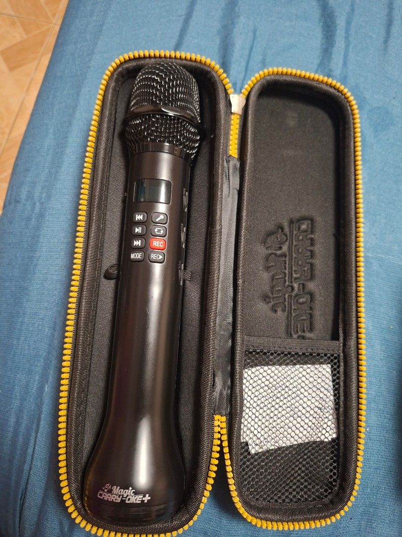 MAGIC CARRY OKE PLUS (Category: Voice Recorders) located in Cainta. Submitted by ennarrivera. (Listing ID 1462517834, Image 2). Description: - MAGIC CARRY OKE PLUS microphone - Sleek black design - Comes with a protective yellow-lined carrying case - Portable and convenient for on-the-go singing - Easy-to-use controls on the handle - Features a clear digital display.