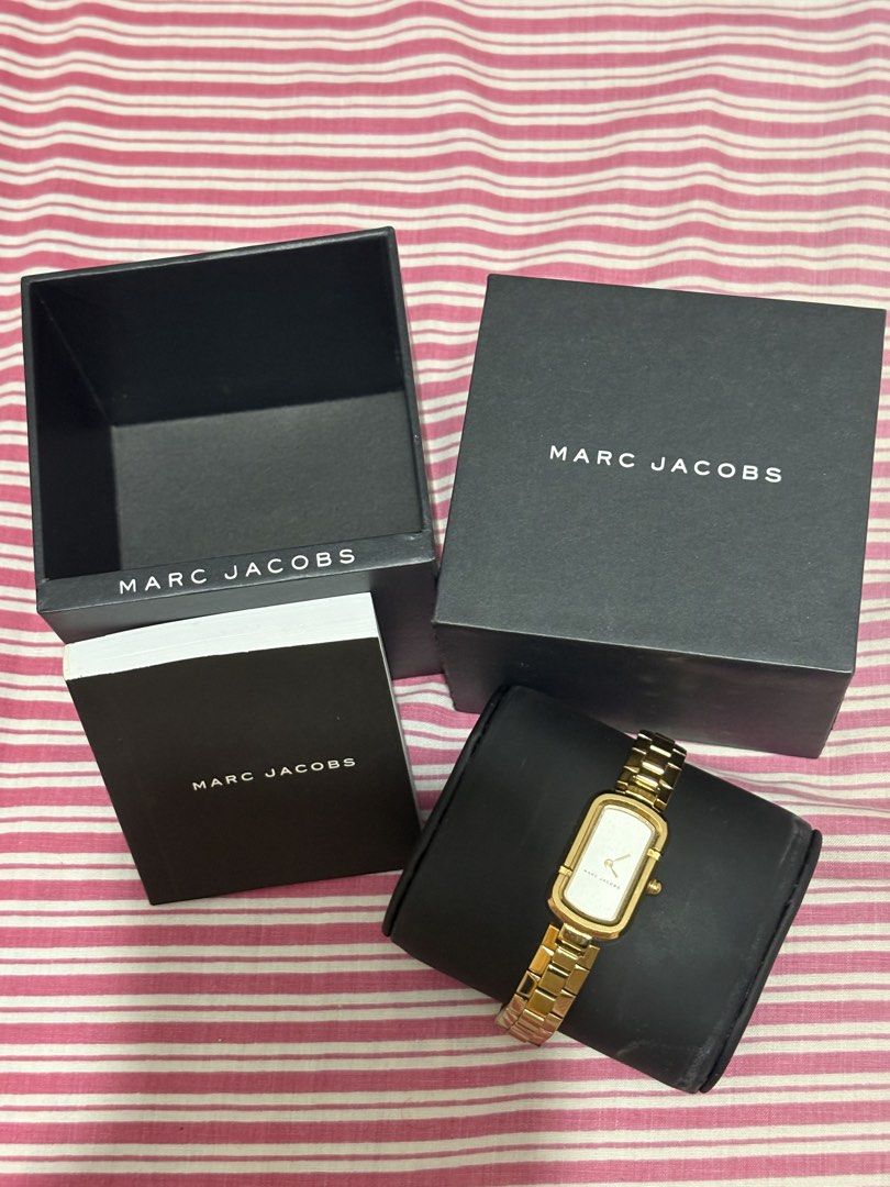 Marc Jacobs Gold Tone Rectangle Watch (Category: Women's Watches) located in Manila. Submitted by nykji96 (Listing ID 1462535172, Image 1). Description: - Authentic Gold Tone Marc Jacobs Watch - Elegant White Rectangular Dial - Comes with Original Box and Packaging - Versatile for Everyday or Dressy Occasions.
