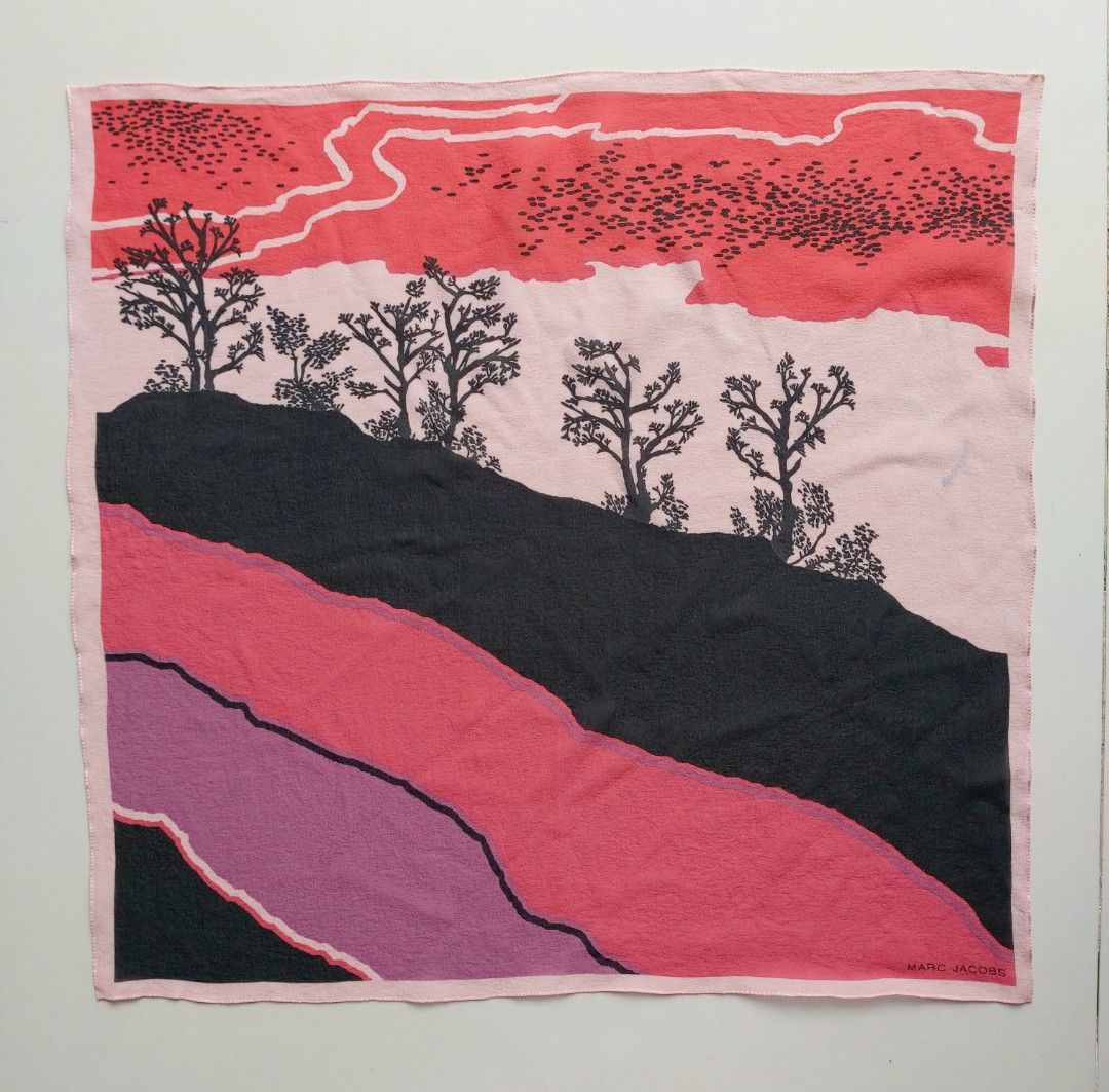 Marc Jacobs Landscape Print Small Scarf (Category: Scarves) located in Lapu Lapu. Submitted by agnesapm_29813 (Listing ID 1462603625, Image 1). Description: - Authentic Marc Jacobs small scarf - Unique landscape print with trees on a hill - Eye-catching and colorful design - Approximate dimensions: 17 inches x 18 inches - Versatile accessory to elevate outfits or bags.
