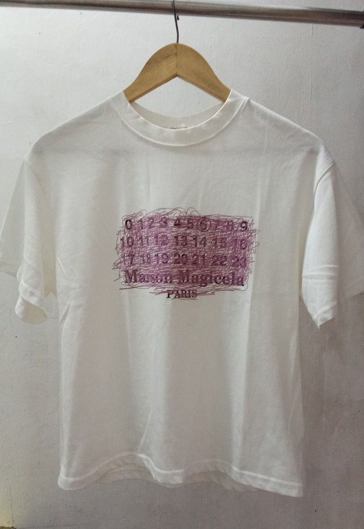 Margiela Numeric logo TShrt (Category: Shirts) located in Manila. Submitted by eriiicaspage (Listing ID 1462449389, Image 3). Description: PreOwned LkeNew Lightly Used Margiela Numers logo t-shirt Medium-Large Cotton - Features the iconic number print with unique scribbled details - Classic crew neck and short sleeve design - Ideal for everyday casual wear No flaws GOod Condition 9/10 .
