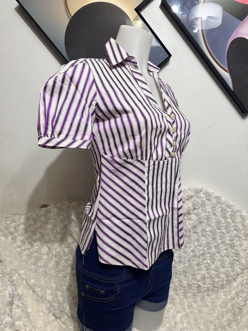 Marks & Spencer Purple and White Striped Button-Up Blouse (Category: Blouses) located in Marikina City. Submitted by lorradel (Listing ID 1462455372, Image 2). Description: - Short-sleeved collared blouse - Purple and white vertical stripe pattern - Button-up front - Cinched waist for a flattering fit - Side slits on the hem - Versatile: pairs well with jeans or shorts - MAY HAVE some washable stains (hindi maiiwasan) needs washing; had been stor
