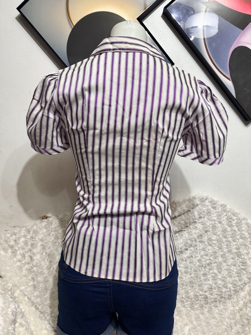 Marks & Spencer Purple and White Striped Button-Up Blouse (Category: Blouses) located in Marikina City. Submitted by lorradel (Listing ID 1462455372, Image 3). Description: - Short-sleeved collared blouse - Purple and white vertical stripe pattern - Button-up front - Cinched waist for a flattering fit - Side slits on the hem - Versatile: pairs well with jeans or shorts - MAY HAVE some washable stains (hindi maiiwasan) needs washing; had been stor