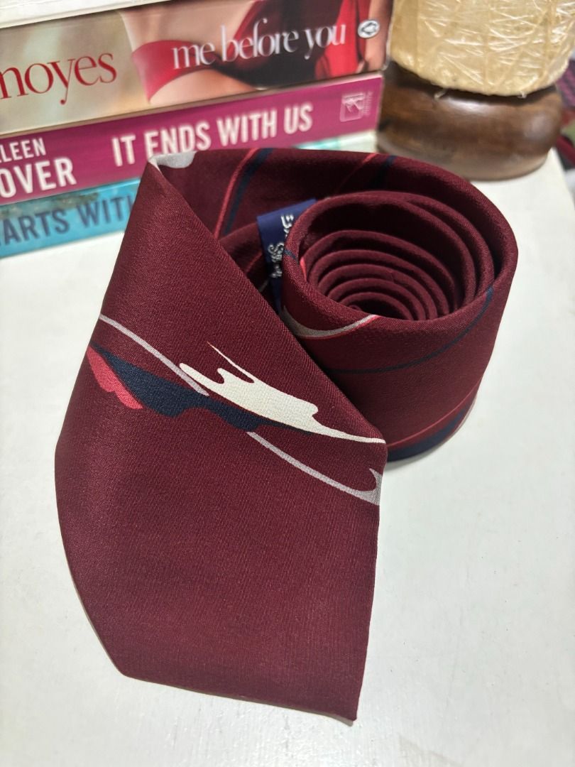 Maroon Silk Tie with Abstract Pattern - Silkoof (Category: Ties) located in Baao. Submitted by apr1979 (Listing ID 1462440590, Image 2). Description: - Stylish maroon silk tie - Features a unique abstract pattern - Colors: Shades of red, white, and blue - Material: 100% Silk - Ideal for formal occasions and elevating work outfits.