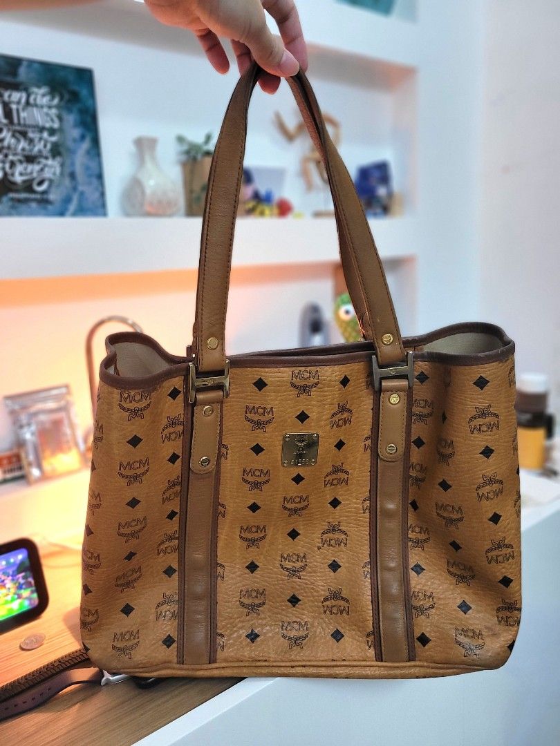 MCM Cognac Visetos Tote Bag (Category: Luxury Bags & Wallets) located in Antipolo. Submitted by dlolin (Listing ID 1462644744, Image 1). Description: - Classic MCM tote bag - Features iconic Visetos print - Genuine leather trim and handles - Interior pockets for organization - Minor signs of wear on corners and inside - Perfect for everyday use.