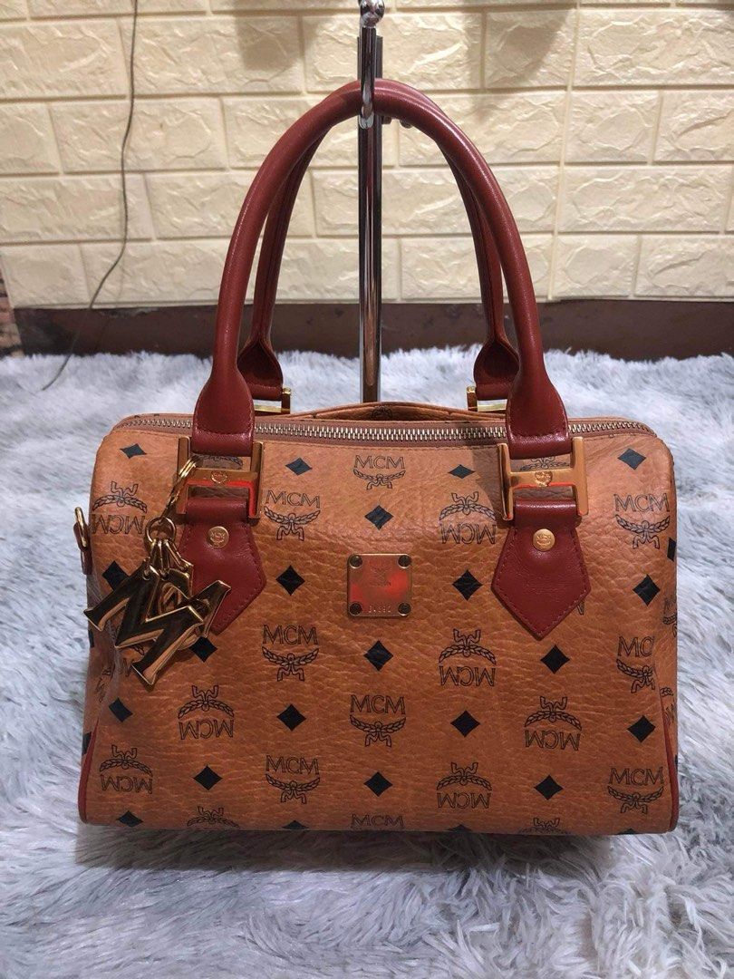MCM Monogram Boston Bag with Charm (Category: Luxury Bags & Wallets) located in Manila. Submitted by dapixphot28865 (Listing ID 1462456490, Image 1). Description: - Classic MCM monogram Boston bag - Includes signature MCM charm - Features leather handles and trim - Secure zipper closure - Spacious interior, ideal for daily use.