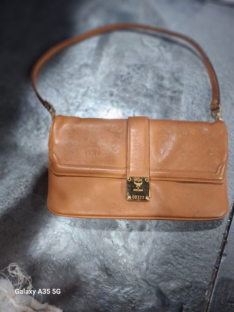 MCM Monogram Leather Shoulder Bag (Category: Luxury Bags & Wallets) located in Cavite. Submitted by bee.geema (Listing ID 1462534196, Image 1). Description: - Authentic MCM shoulder bag - Classic all-over monogram pattern - Gold hardware details - MCM logo lining inside - Adjustable strap for comfort - Ideal for everyday wear.