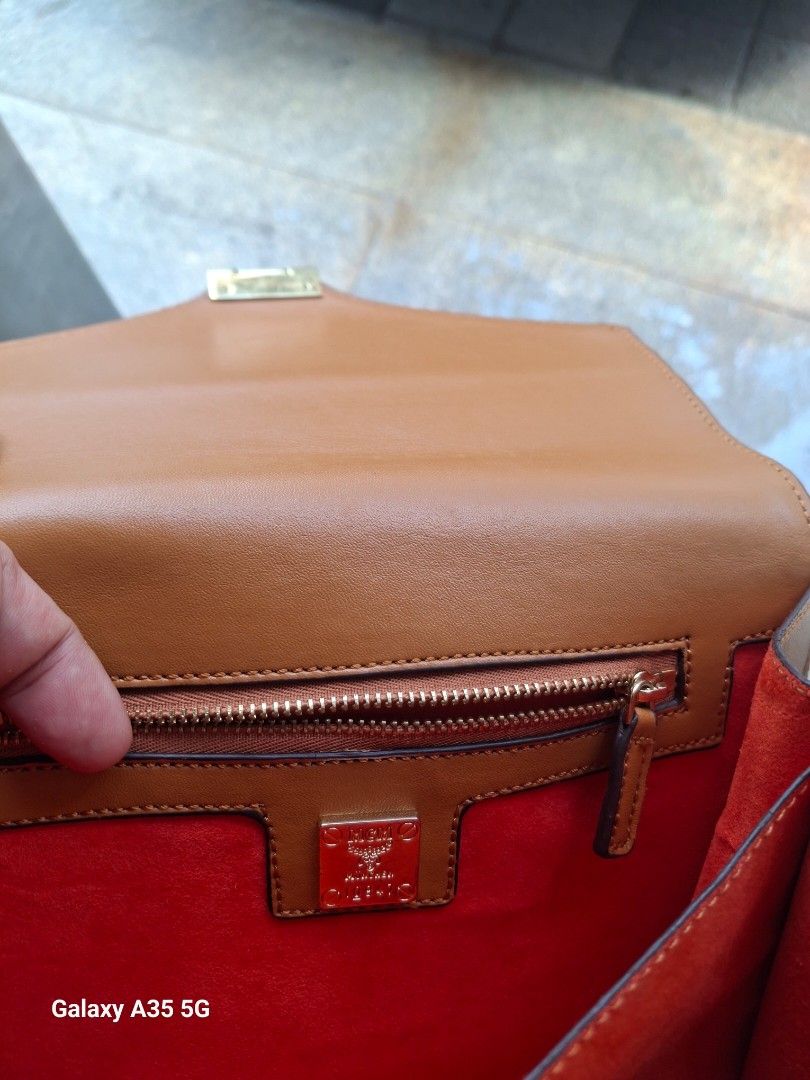 MCM Monogram Shoulder Bag (Category: Luxury Bags & Wallets) located in Cavite. Submitted by bee.geema (Listing ID 1462505984, Image 2). Description: - Authentic MCM monogram shoulder bag - Elegant gold hardware clasp closure - Interior: 1 zippered pocket, 1 slip pocket - Luxurious orange suede lining - Comes with a small leather tag - Adjustable strap for comfortable wear.