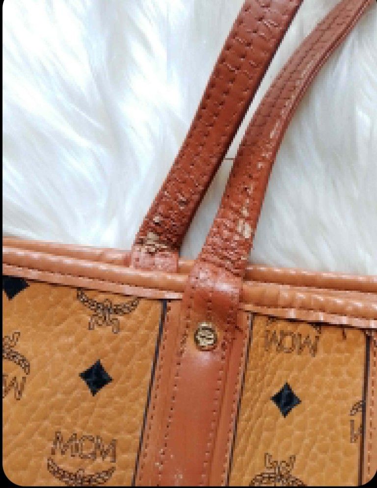 MCM Monogram Tote Bag (Category: Luxury Bags & Wallets) located in Midsayap. Submitted by purse_gedo (Listing ID 1462615442, Image 2). Description: - Classic MCM tote bag - Brown monogram print with leather trim - Interior with checkered lining and MCM logo - Handles show wear and peeling - Ideal for everyday use.