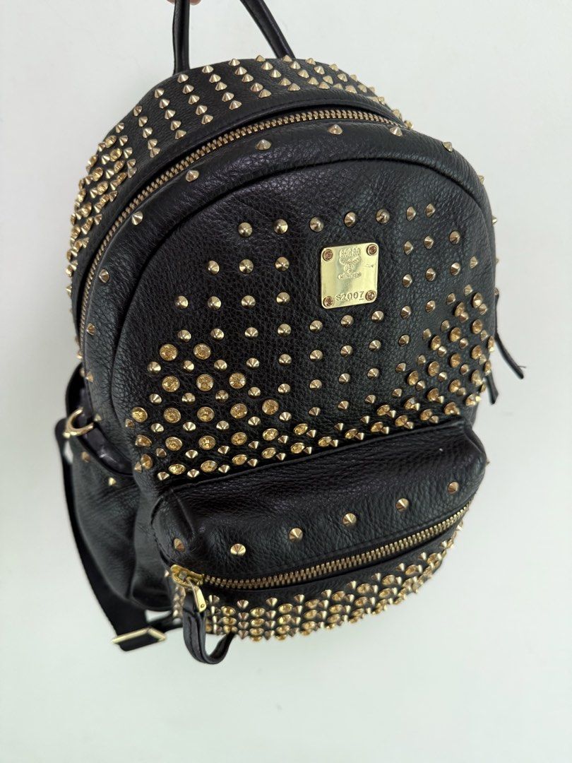 MCM Studded Mini Black Leather Backpack (Category: Backpacks) located in Manila. Submitted by limsanity03 (Listing ID 1462594314, Image 3). Description: - Genuine black leather MCM backpack - Stylish gold stud detailing - Convenient front zip pocket - Adjustable straps for comfort - Prominent MCM logo plate - Spacious interior for essentials - Ideal for everyday use and travel.