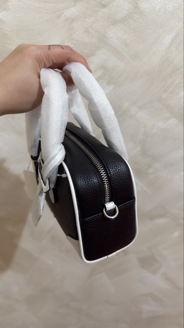 Michael Kors Black & White Leather Mini Duffle Bag (Category: Cross-body Bags) located in Las Pinas. Submitted by mharjrahm (Listing ID 1462645861, Image 2). Description: - Brand: Michael Kors - Style: Mini Duffle Bag - Material: Black pebbled leather - Accents: White trim and base - Hardware: Silver - Closure: Zipper - Handles: Top handles - Condition: New with original tags - Size: Ideal for essentials 4900 only laspiñas location actual photo p
