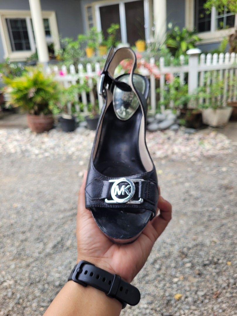 Michael Kors Black Leather Studded Wedge Sandals (Category: Wedges) located in Manila. Submitted by mrs.jane08 (Listing ID 1462491450, Image 2). Description: - Brand: Michael Kors - Material: Black Leather - Details: Silver stud embellishments, iconic MK logo buckle - Closure: Adjustable slingback strap with buckle - Heel Type: Platform wedge - Style: Chic and versatile, perfect for dressing up or down.