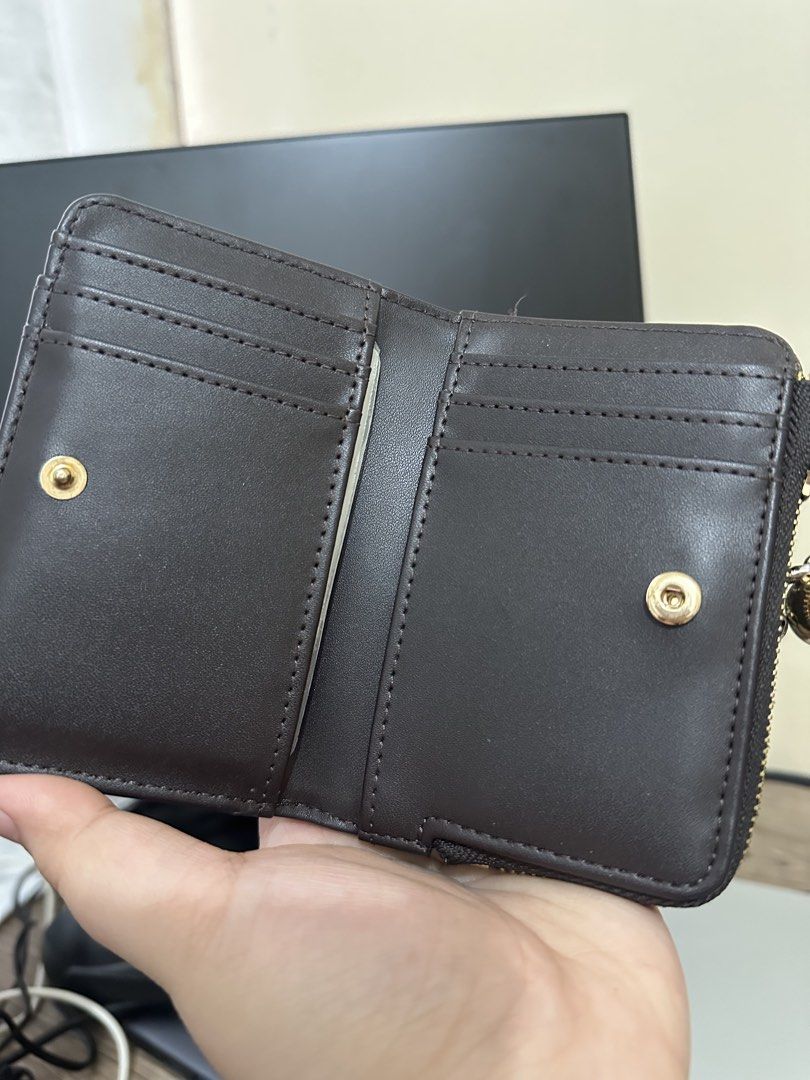 MNG Brown Zipper Wallet (Category: Wallets & Card holders) located in Dasmarinas. Submitted by paulaaa_ (Listing ID 1462444666, Image 2). Description: - Brown MNG wallet - Zipper closure - Multiple card slots inside - Small and compact design - Gold hardware with ball charm detail - Ideal for organizing cards and cash.