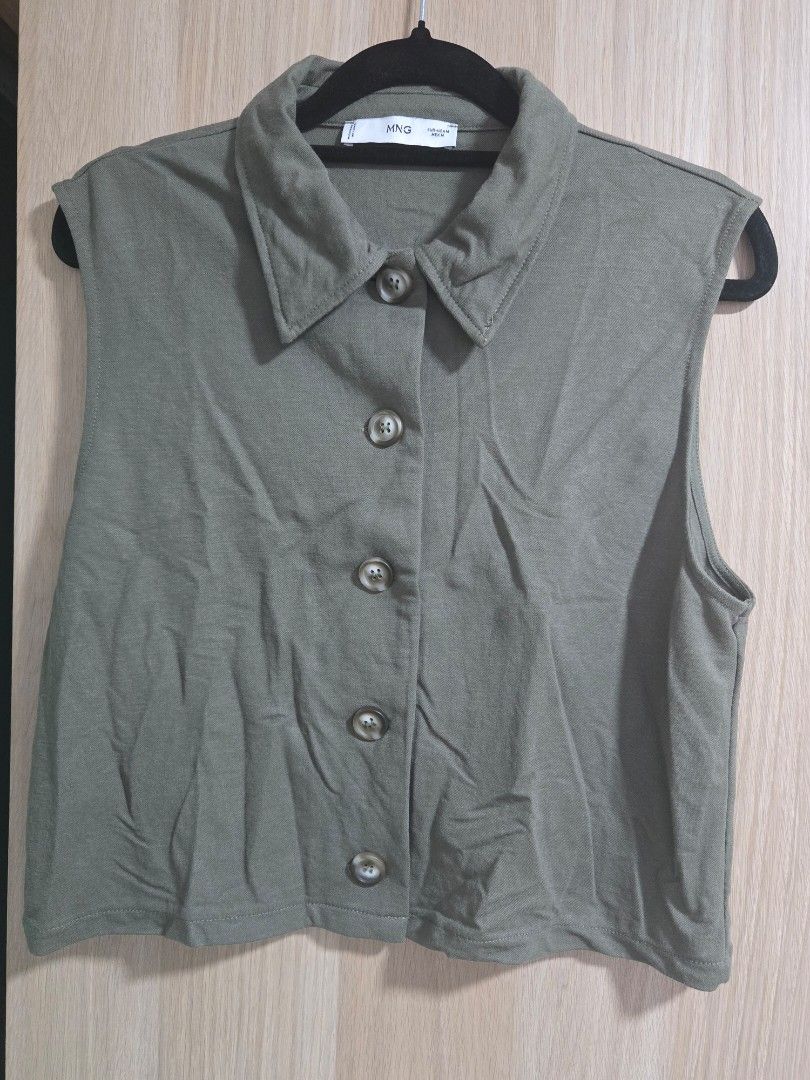 MNG Olive Green Button-Up Vest Top Size M (Category: Sleeveless) located in Quezon City. Submitted by mrstan777 (Listing ID 1462499930, Image 1). Description: - Olive green vest from MNG/Mango - Size: Medium - Features: Button-up front, collared neckline - Material: Viscose and polyamide blend - Style: Great for layering over t-shirts or dresses, versatile wardrobe piece.