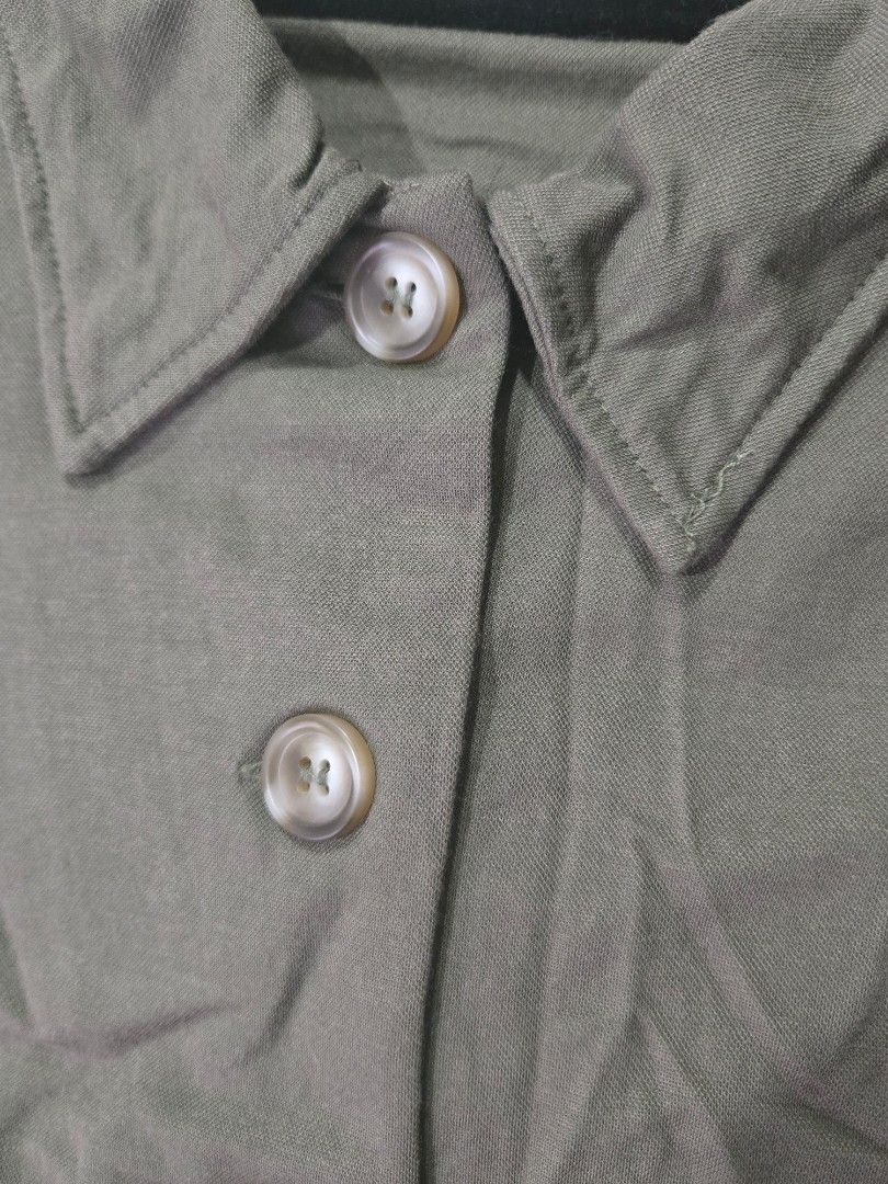 MNG Olive Green Button-Up Vest Top Size M (Category: Sleeveless) located in Quezon City. Submitted by mrstan777 (Listing ID 1462499930, Image 2). Description: - Olive green vest from MNG/Mango - Size: Medium - Features: Button-up front, collared neckline - Material: Viscose and polyamide blend - Style: Great for layering over t-shirts or dresses, versatile wardrobe piece.